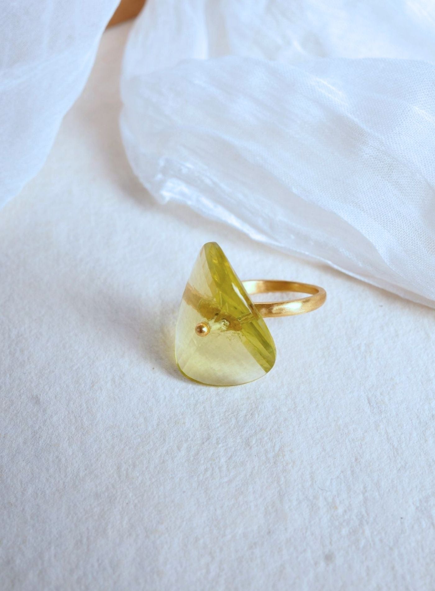 K18 yellow gold Infinity Ring featuring a hand-cut and hand-polished natural lemon quartz gemstone in a modern sculptural setting.